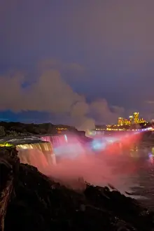 Images Dated 20th July 2008: USA, New York, Niagara Falls. Twilight view of the waterfalls and mist lit with pink light