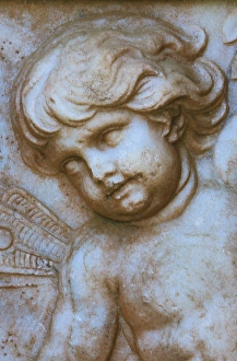 USA, North America; South Carolina, Charleston. A cherub on a monument in Magnolia
