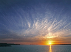 Images Dated 21st August 2012: USA, North Dakota, Lake Sakakawea. Cirrus clouds take on the colors of the sun setting