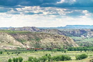 Theodore Roosevelt National Par Prints: USA, North Dakota, Theodore Roosevelt National Park. Train passing through park
