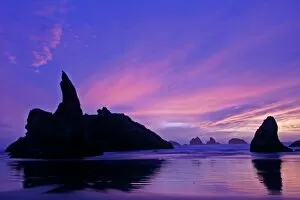 USA, Oregon, Bandon Beach. Silhouette of sea stack formations at sunset. Credit as