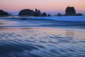 USA, Oregon, Bandon. Sunset on beach sea stacks