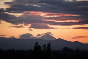USA, Oregon, Bend. Clouds gather around the Soth and Middle Sisters at sunset in Deschutes County