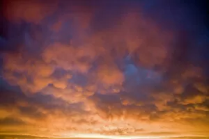 USA, Oregon, Bend. Mammatus clouds take on a variety of colors at sunset in Deschutes County