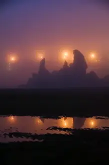 Images Dated 14th August 2007: USA, Oregon, Brandon. City night lights silhouette sea stacks in fog at the beach