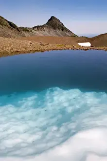 Tarn Prints: USA, Oregon, Broken Top. Submerged ice reflects the blue sky in a tarn near Broken