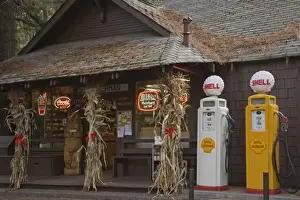 Fuel Prints: USA, Oregon, Camp Sherman. Two vintage gasoline pumps displayed in front of store