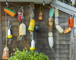 Hanging Prints: USA, Oregon, Cannon Beach. Buoys hang on side of house