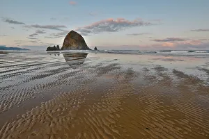 Cannon Beach Prints: USA, Oregon, Cannon Beach. Sunset golden colors with ripples in sandy beach and The Haystack Rock