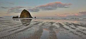 Cannon Beach Prints: USA, Oregon, Cannon Beach. Sunset golden colors with ripples in sandy beach and The Haystack Rock