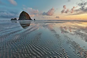 Cannon Beach Prints: USA, Oregon, Cannon Beach. Sunset golden colors with ripples in sandy beach and The Haystack Rock