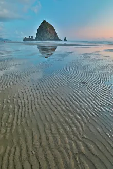 Cannon Beach Prints: USA, Oregon, Cannon Beach. Sunset golden colors with ripples in sandy beach and The Haystack Rock