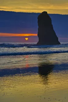 USA, Oregon, Cannon Beach. Sunset on lone sea stack