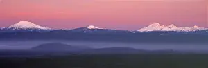 Snow Capped Prints: USA, Oregon, Cascades Range. The pink blanket of sunrise warms the Oregon Cascades
