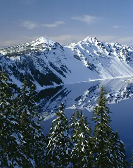 USA, Oregon. Crater Lake National Park, winter snow on west rim of Crater Lake with The Watchman