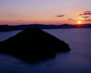 USA, Oregon. Crater Lake National Park, sunrise over Wizard Island and Crater Lake in summer