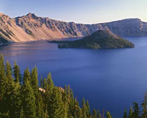 USA, Oregon, Crater Lake National Park. Sunrise on west rim of Crater Lake with Hillman Peak