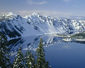 USA, Oregon. Crater Lake National Park, winter snow on west rim of Crater Lake with The Watchman