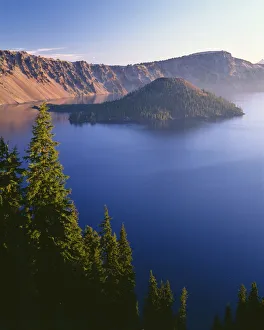 USA, Oregon, Crater Lake National Park. Sunrise on west rim of Crater Lake with Wizard Island