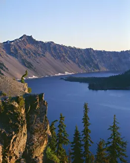 USA, Oregon, Crater Lake National Park. Sunrise on west rim of Crater Lake with Hillman Peak