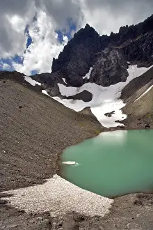 Tarn Prints: USA, Oregon, Three Fingered Jack. A small iceberg floats in the tarn below Three