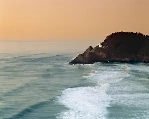 Heceta Head Prints: USA, Oregon, Heceta Head. A mellow sunset turns the sky golden pink at Heceta Head