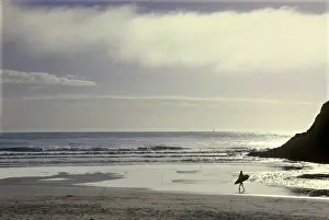 Active Prints: USA, Oregon, near Heceta Head, lone surfer going out into the Pacific Ocean