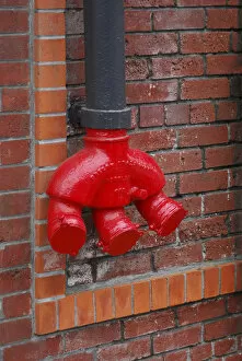 USA, Oregon, Portland. Bright red standpipe outside of brick building. Credit as