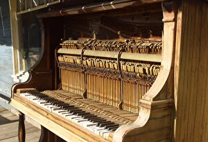 USA, Oregon, Shaniko. Close-up of old piano on main street in ghost town. Credit as