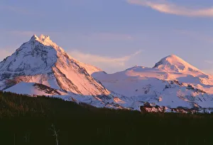 USA, Oregon. Three Sisters Wilderness, sunset light on North (left) and Middle Sister