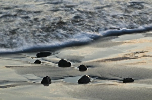 Nancy Rotenberg Prints: USA, Oregon. Wet beach sand and rocks at sunset on shoreline. Credit as: Nancy Rotenberg