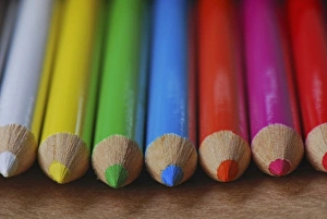 Point Prints: USA, Row of multicolored colored pencils lay on table
