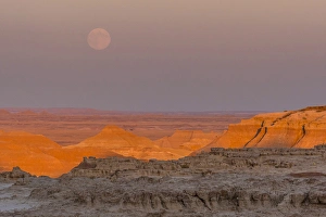 Moonrise Prints: USA, South Dakota, Badlands National Park. Moonrise over rugged landscape at sunset