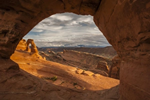 Images Dated 3rd December 2014: USA, Utah, Arches National Park. Delicate Arch at sunset. through another arch Credit as