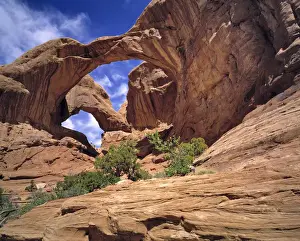 Ric Ergenbright Prints: USA, Utah, Arches NP. Hikers rest below Double Arch in Arches National Park, Utah