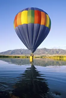 Touch Prints: USA, Utah, Cache Valley. Basket of hot air balloon intentionally touches water of