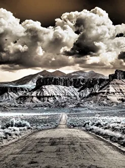 Infrared Prints: USA, Utah. Infrared of road leading to Fisher Tower and large clouds