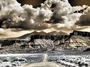 Infrared Prints: USA, Utah. Infrared of road leading to Fisher Tower and large clouds