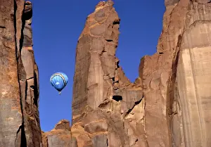 USA, Utah, Monument Valley. A hot-air balloon is suspended in Monument Valley, Utah