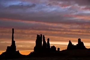 Images Dated 29th October 2007: USA, Utah, Monument Valley National Park. Sunrise creates silhouettes of totem pole-like