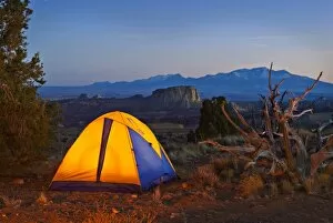 USA, Utah. A tent glowing at dusk on the San Rafael Swell