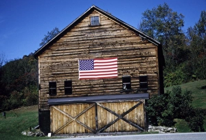 Log Cabin Prints: USA, Vermont. Log cabin with American flag on side