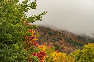 USA, Vermont, New England, Stowe Mt. Mansfield parking lot view with fog on mountains