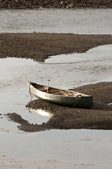 Solitary Prints: USA, WA, Bainbridge Island. Low tide in Fletcher Bay beaches canoe