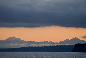 USA, WA, Puget Sound. Cascade Mountains predawn with dense deck of storm clouds above