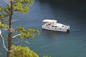 Sucia Island Prints: USA, WA, San Juan Islands. Motor catamaran moored in Snoring Bay of Sucia Island State Park