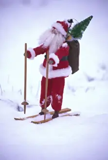 Figurine Prints: USA, Washington, Bellingham. Toy Santa Claus on skis and snow. Credit as: Steve Satushek