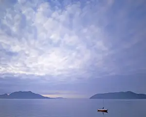 USA, Washington, Orcas Island, Sailboat at dawn in Doe Bay