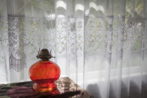 USA, Washington, San Juan Islands. Oil lamp and curtained window in Old School house
