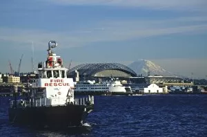 USA, Washington, Seattle, Elliott Bay. Fire rescue boat in Elliott Bay with Safeco Field and Mt